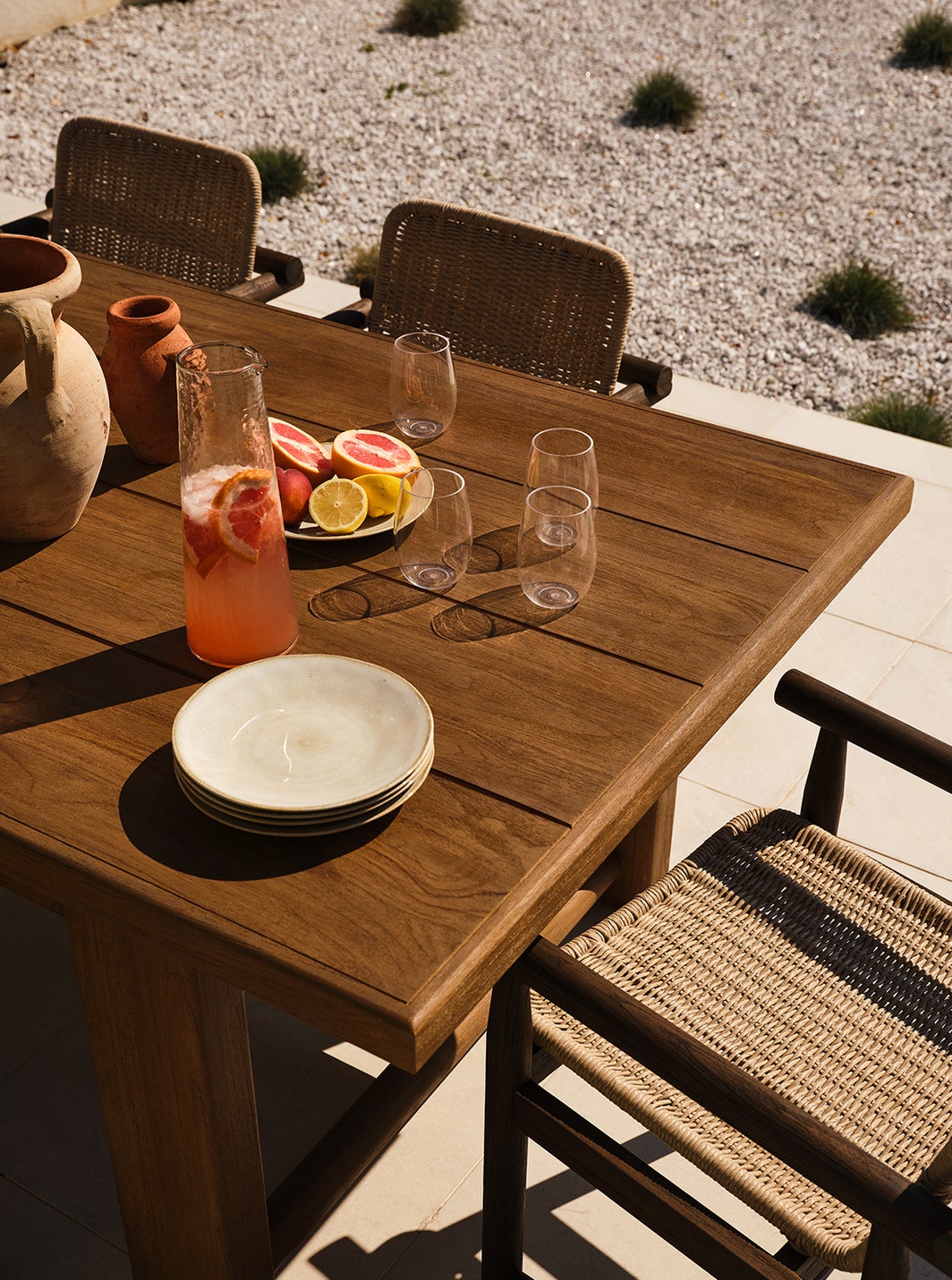 Lumi Outdoor Dining Table and Dume Outdoor Dining Armchair by Amber Lewis for Four Hands