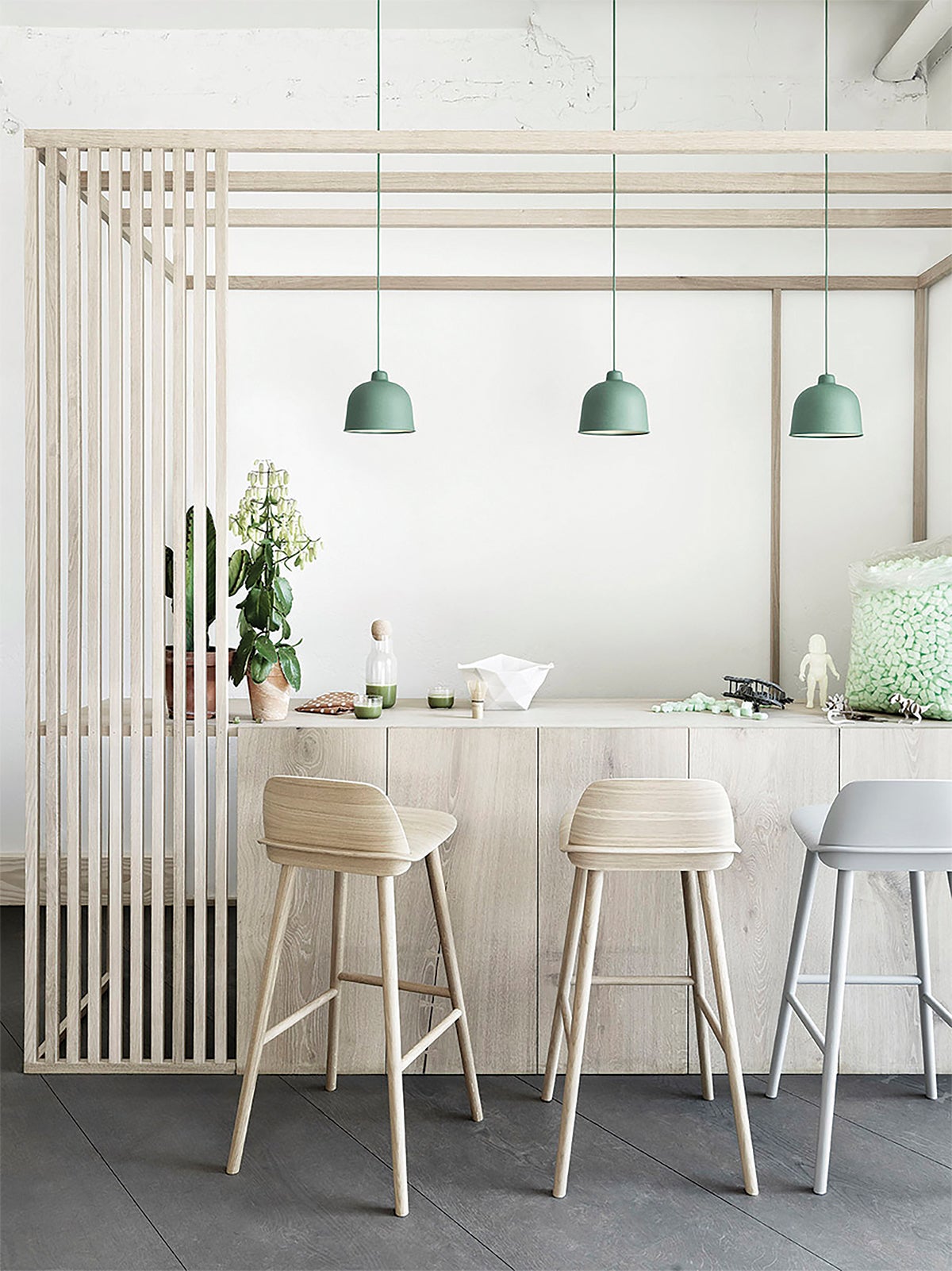 Three green lights over a beige dining area