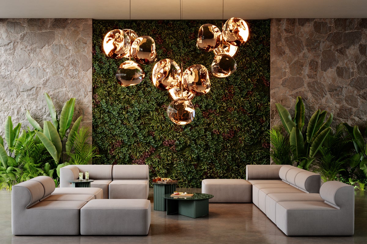 A plant wall and additional, flanking plants in a large sitting area.