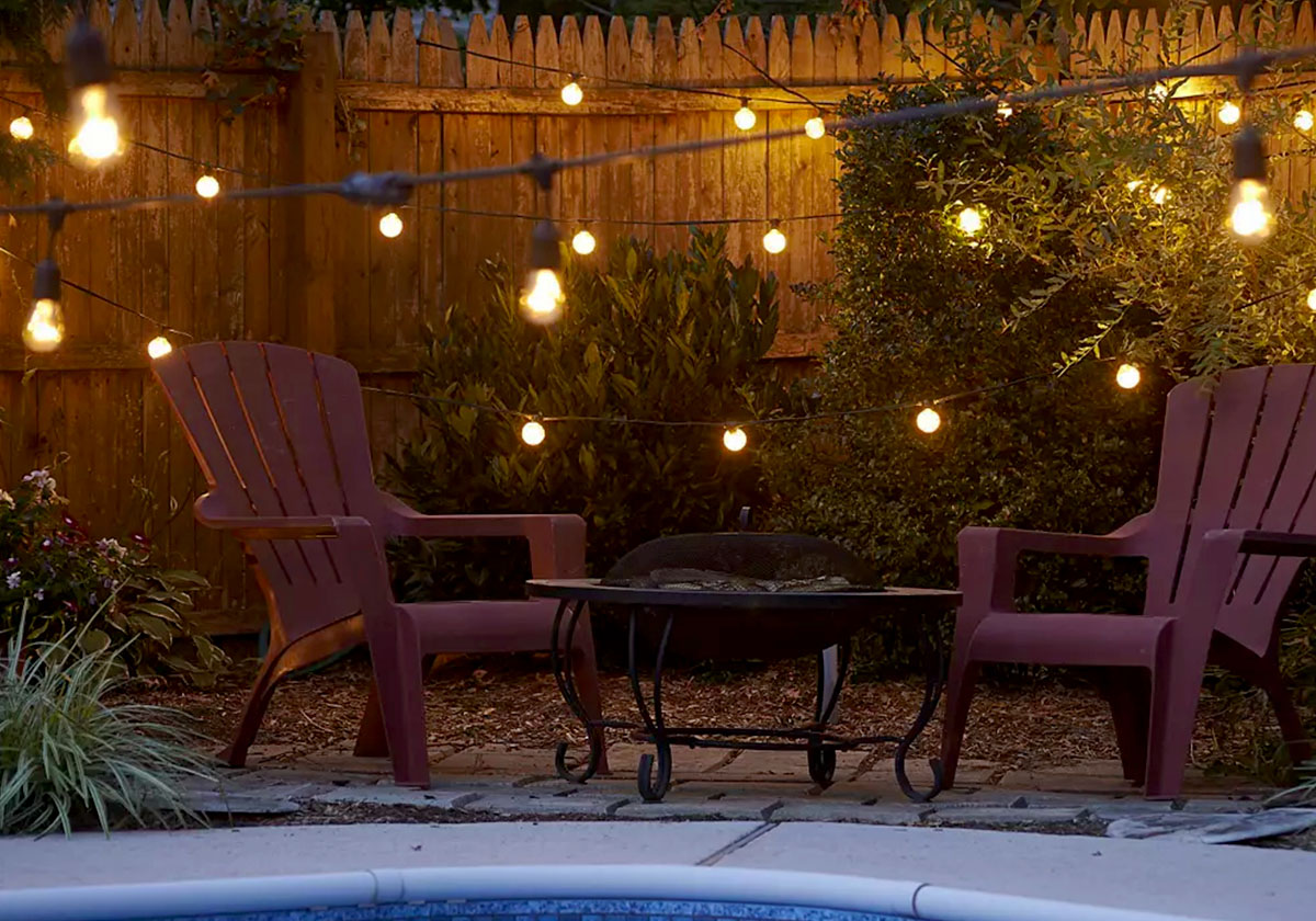String lights cascade by a poolside.