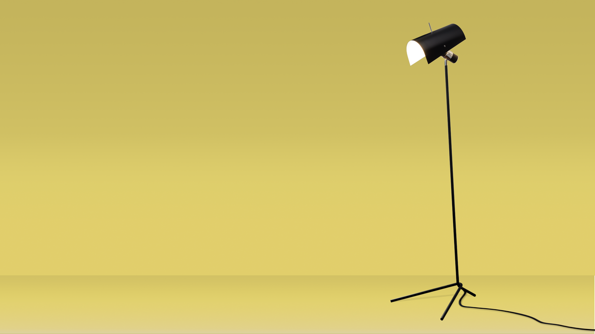 Black floor lamp against yellow background
