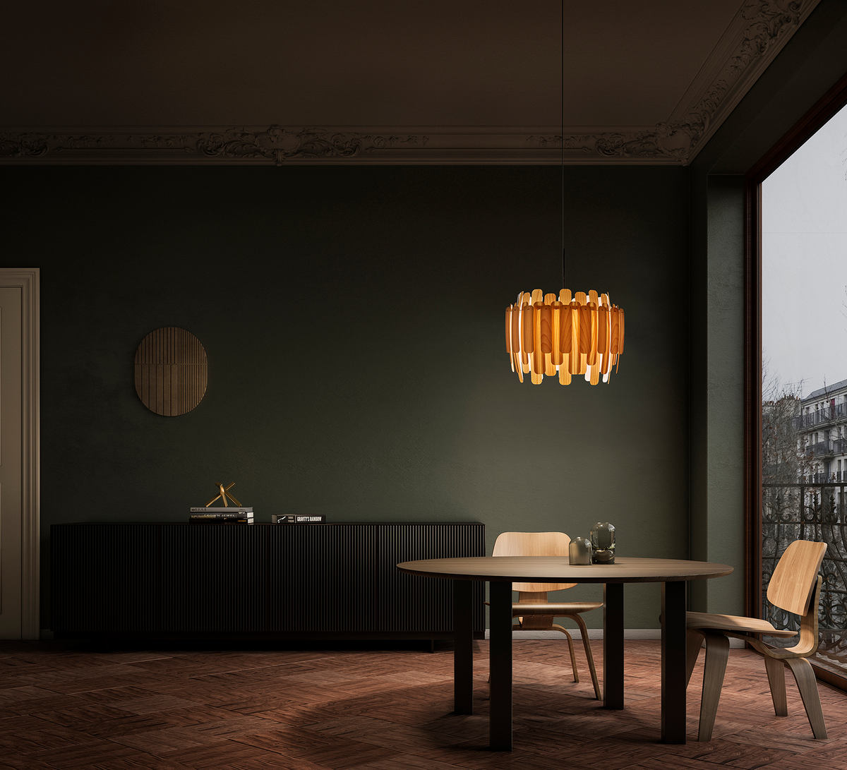 Amber pendant light above a dining set in a dark green room.