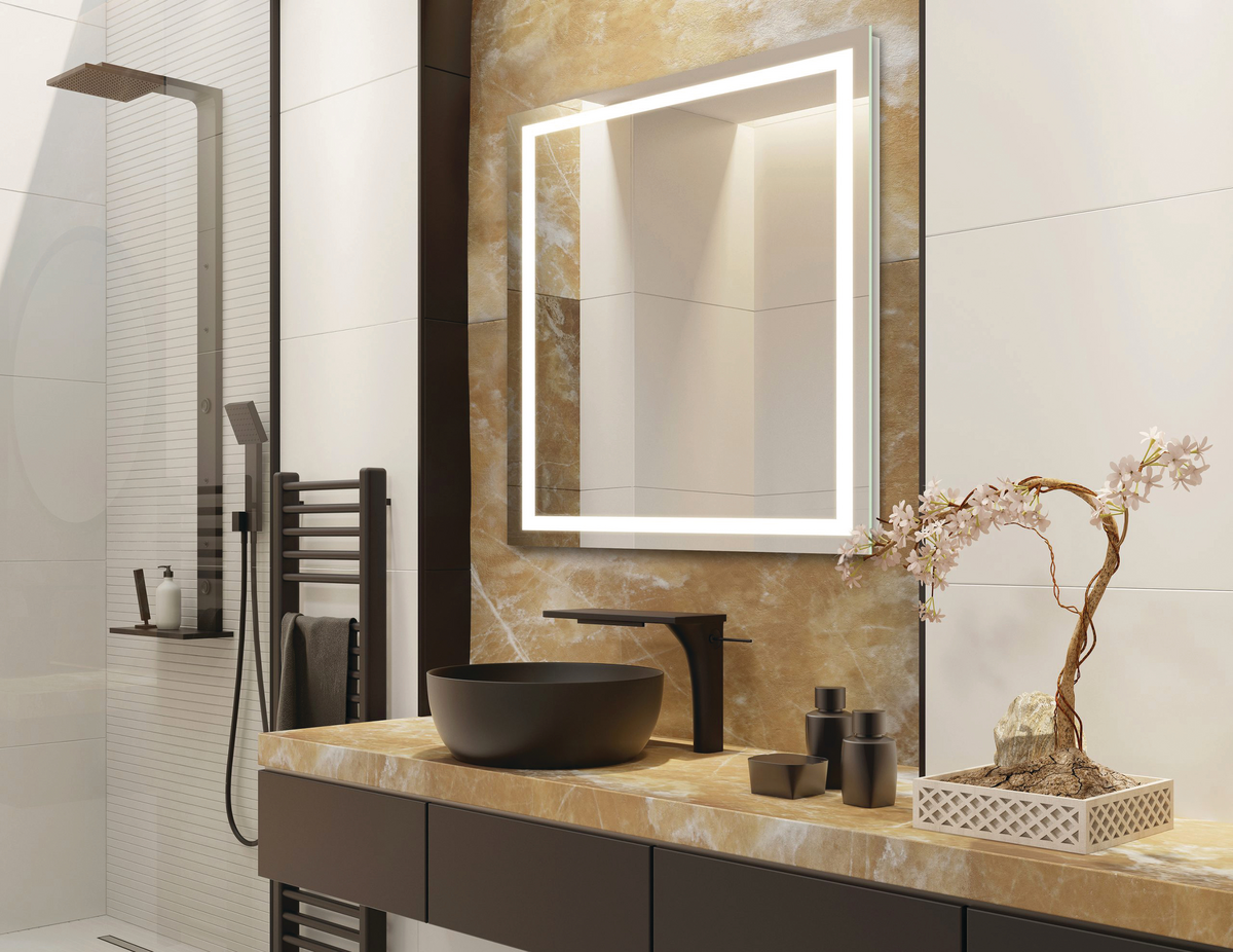 A lighted mirror in a modern bathroom.