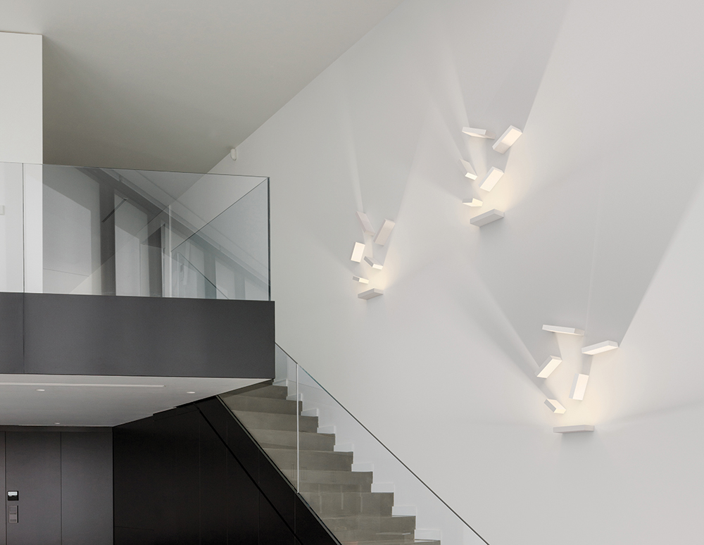 White, rectangular wall lights on the side of a modern staircase