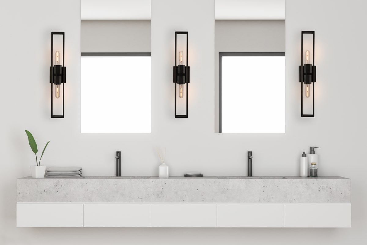 A row of wall sconces between mirrors in a modern bathroom.